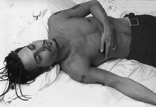 johnny depp shirtless pics. Johnny Depp lying on bed