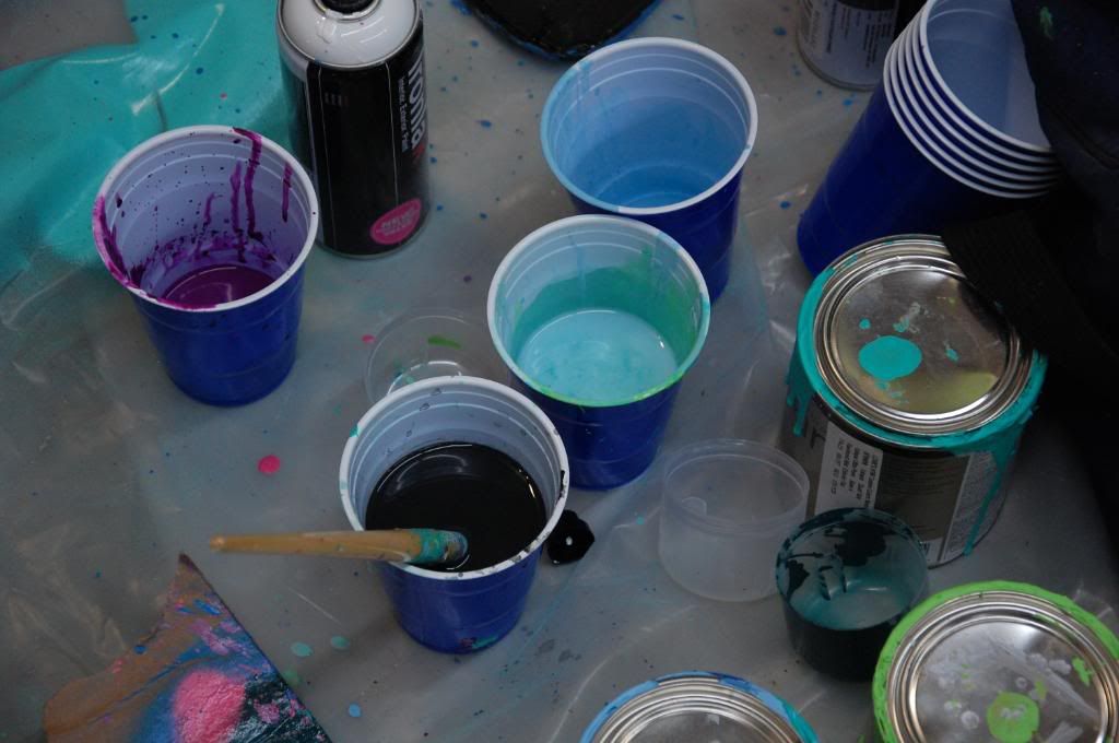 Plastic cups held the fine mixtures of color that was used for the fine details. 